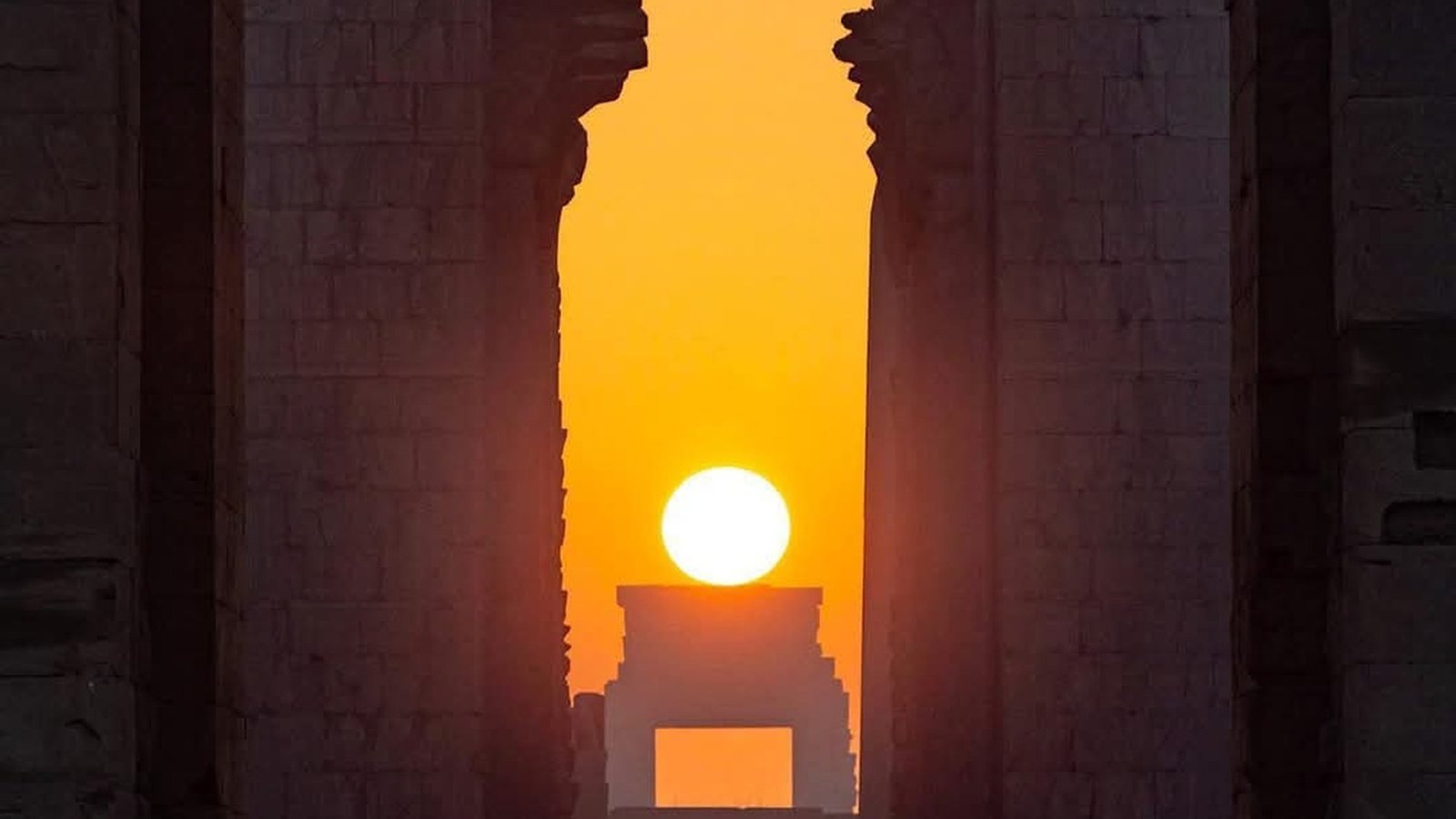 Warm sunset through a monumental temple axis in Luxor